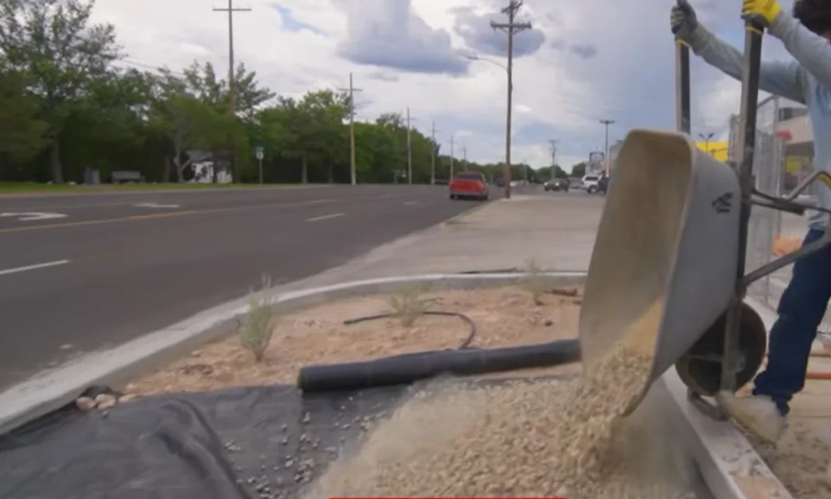 Rock installation las cruces nm wheelbarrow spreading gravel over weed barrier fabric